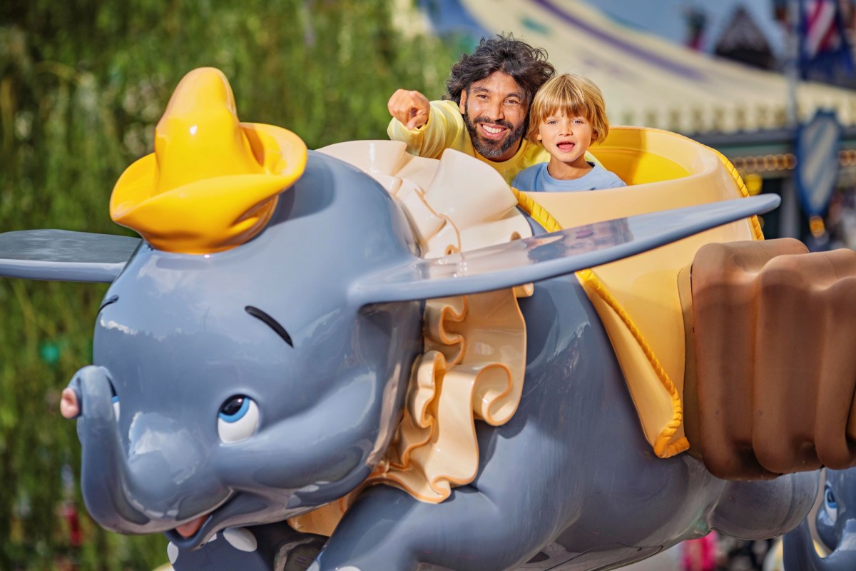 guests on dumbo the flying elephant disneyland